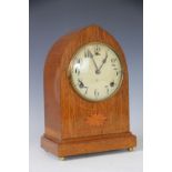 An Edwardian inlaid walnut lancet shaped mantel clock,