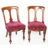 A set of six Victorian mahogany dining chairs, with striped claret upholstery,