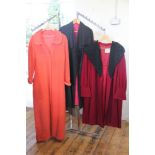 A Louis Watkins Couture black crepe evening coat with waterfall collar and a red wool coat with