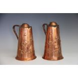 A pair of Art Nouveau copper ewers by Joseph Sankey, decorated with stylised flowers,