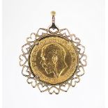 A gold sovereign set pendant, the George V sovereign dated 1927, within heart detailed mount,