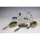A collection of dressing table wares, to include; a glass jar with silver and blue enamelled cover,