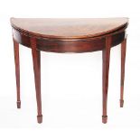 A George III inlaid mahogany demi-lune tea table, with folding top, on tapered legs,