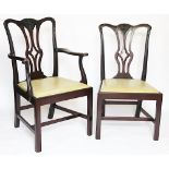 A set of eight George III style carved mahogany dining chairs, including two with arms,