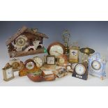 An assortment of barometers and time pieces, to include a fret cut barometer with inset thermometer,