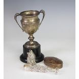 A silver two handled pedestal trophy, Birmingham 1932, a pair of silver sugar nips,