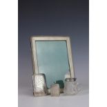 A silver photograph frame, stamped 'Sterling' with engine turned and beaded detail and oak back,