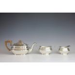 A three piece silver plated tea service, Roberts and Belk, each of low oval form,