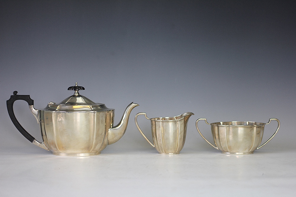 A silver three piece tea service, Barker Brothers Silver Ltd, Birmingham 1933, each piece of oval,