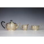 A silver three piece tea service, Barker Brothers Silver Ltd, Birmingham 1933, each piece of oval,