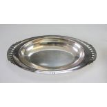 An Art Deco silver plated dish circa 1930, the oval dish with fan cast handles and stepped rim,