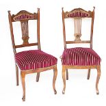 A pair of late Victorian carved walnut dining chairs,