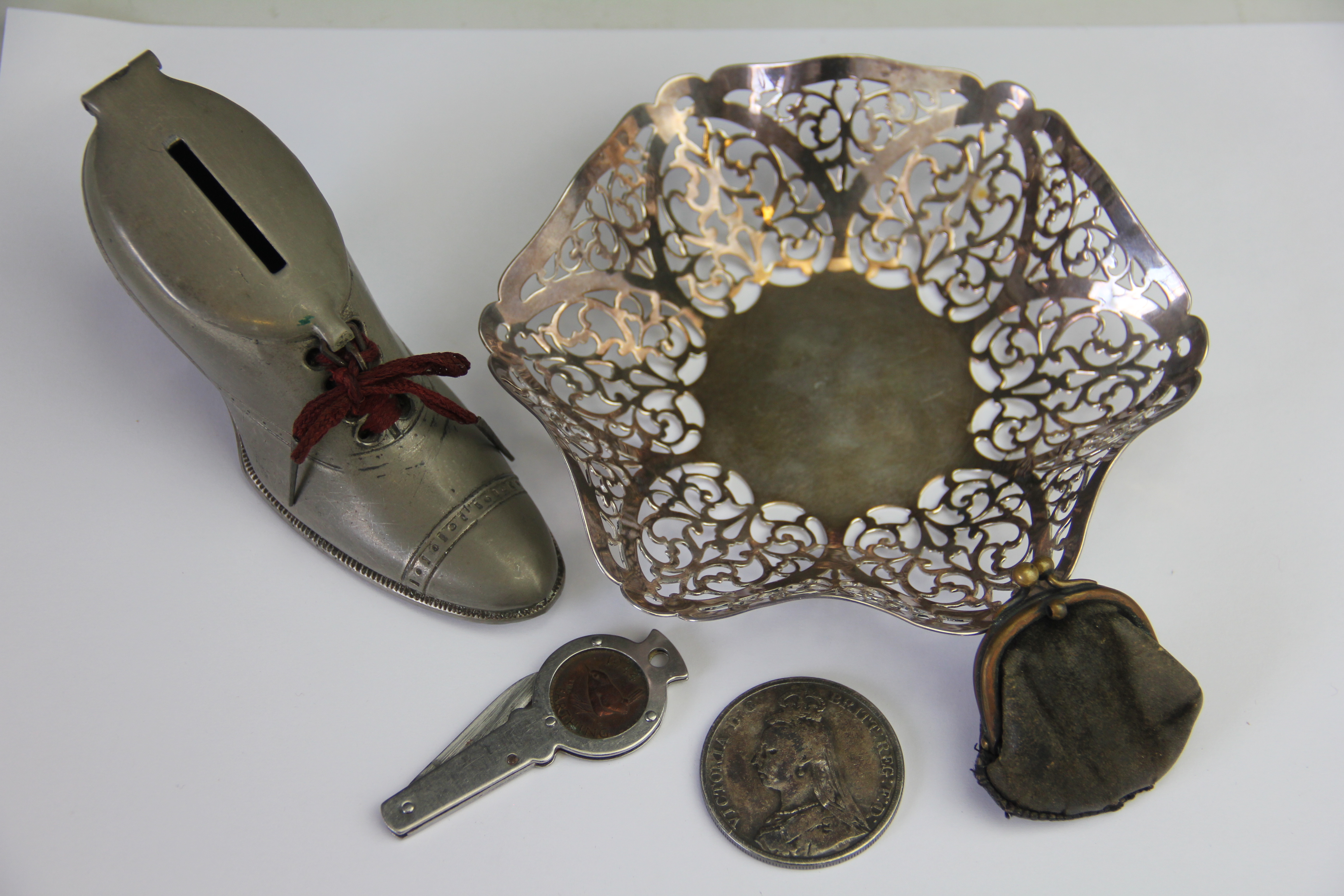 A silver dish, London 1965, of hexagonal form, with pierced scroll rim, weight 3.