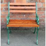 A green painted cast iron garden seat, with slat back and seat,