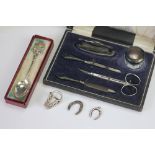 A cased silver manicure set, Chester 1912, comprising scissors, silver topped glass jar, buffer etc,