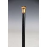 A late 19th / early 20th century yellow metal mounted walking cane, probably French,