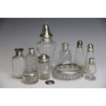 A selection of assorted condiments, scent bottles and jars, including a silver topped glass jar,