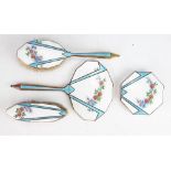 An Art Deco enamelled dressing table set,