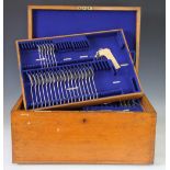 A large Goldsmiths & Silversmiths Co Ltd oak cased part canteen enclosing four lift out trays and