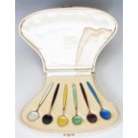 A cased set of Hans Hansen for David Andersen enamelled tea spoons within a fitted Harrods case,