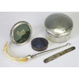 A collection of silver wares to include a silver backed hand mirror, London 1947, Initialled 'M.