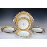 A Stone China armorial part service, comprising six soup bowls and a large platter,