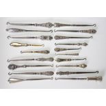 A collection of nineteen silver handled button hooks, Victorian and later,