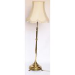 A late Victorian brass adjustable standard lamp, on circular base,