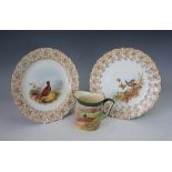 A pair of Royal Worcester plates, each enamelled with grouse within a brown printed border,