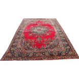 A Persian Tabriz wool carpet, worked with a central floral medallion and corner spandrels,