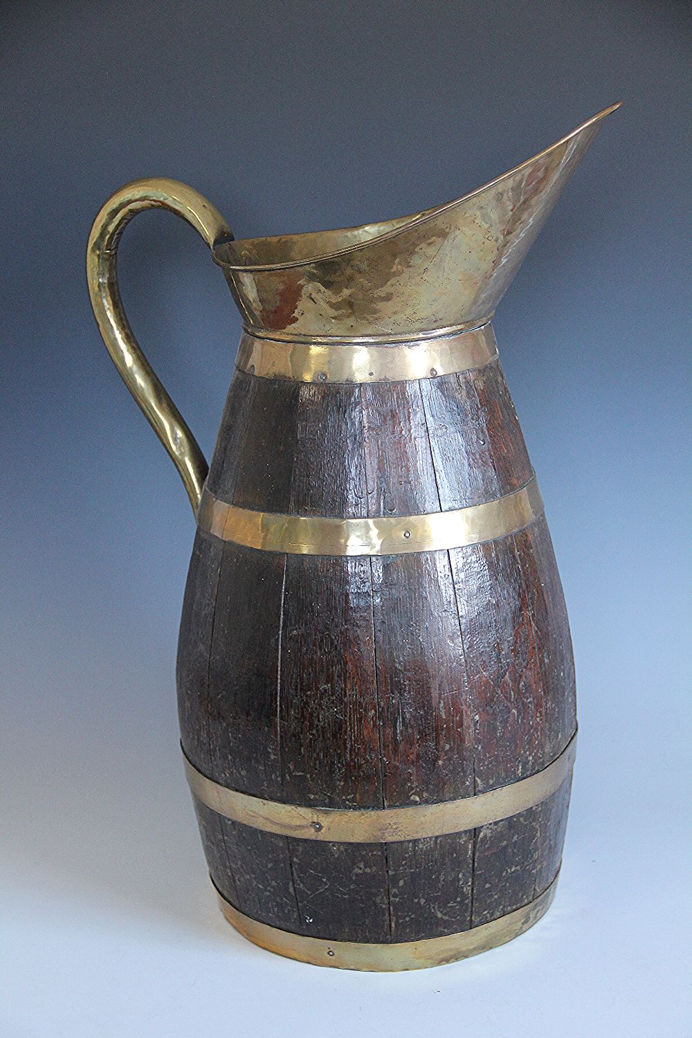 A coopered cider jug or stick stand, with brass bound spout and handle,