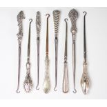 A collection of eight silver handled button hooks, Victorian and later,