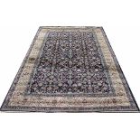 A Kashmir rug, worked with an all over scrolling foliate design against a blue ground,