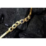 A sapphire and diamond bracelet, designed as six panels of sapphire and diamond clusters,