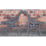 A pair of late 19th century cast iron bench ends, decorated with flowers and scrolls,