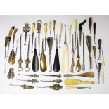 A collection of button hooks and shoe horns, to include silver handled, brass, ivory, resin, ebony,