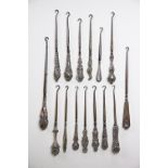 A collection of fifteen silver handled button hooks, Victorian and later,