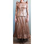 An Edwardian brown satin wedding dress, with simulated pearl trim to collar, cuffs and lapels,