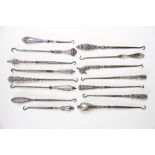 A collection of fifteen silver handled button hooks, Victorian and later,