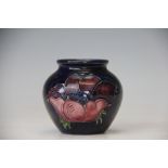 A Moorcroft vase, the ovoid vase decorated with anemone flowers against a cobalt ground,
