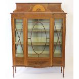 A late Victorian inlaid mahogany break front display cabinet in the manner of Edwards and Roberts,