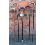 Four walking sticks, including a horn handled example with silver collar, Birmingham 1899,