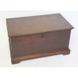 A 19th century oak storage box with hinged cover , raised on plinth base with bracket feet,