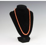 A coral bead necklace, early 20th century, the graduated,