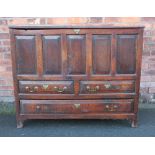 A George III large oak mule chest, the hinged top above a five panel front,