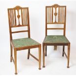 A set of four Arts and Crafts oak dining chairs,