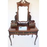 An late Victorian carved mahogany dressing table, with blind fret detailing,