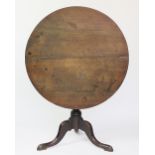 A George III and later oak tilt top occasional table, with turned column, on tripod base,