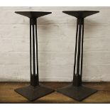 A pair of Arts and Crafts oak tapering slender stands, raised on square canted bases,