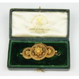 A Victorian gold brooch, designed as three entwined circles,